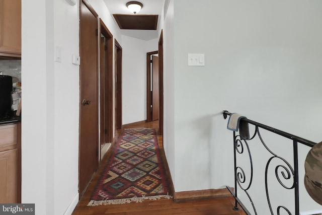 hall with dark wood-style flooring