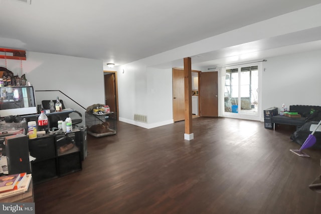 interior space featuring visible vents, baseboards, and wood finished floors