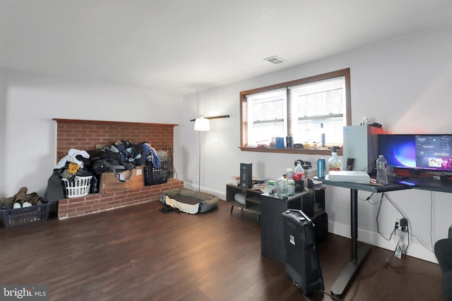 home office with visible vents, baseboards, and wood finished floors