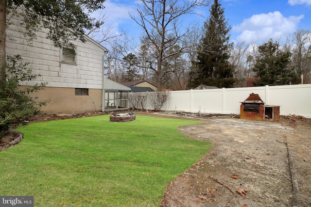 view of yard with a fenced backyard and an outdoor fire pit