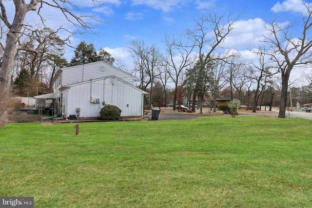 view of side of home featuring a lawn