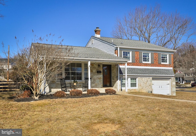 split level home featuring a shingled roof, covered porch, a chimney, a garage, and stone siding