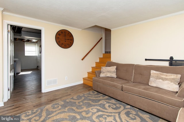 living room featuring stairway, wood finished floors, visible vents, baseboards, and crown molding