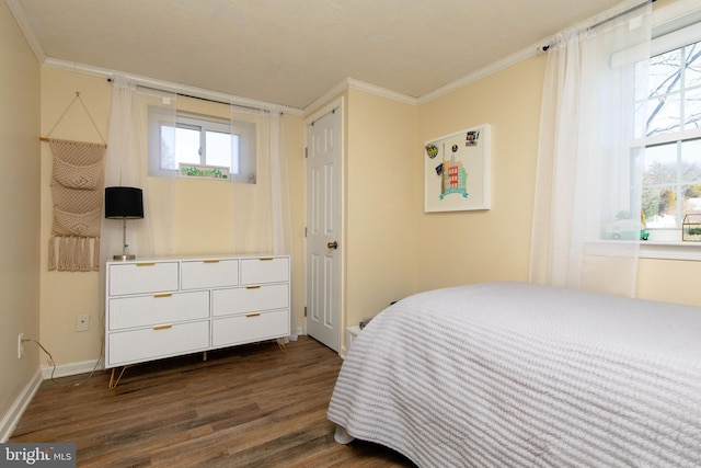 bedroom featuring dark wood-style floors, crown molding, and baseboards