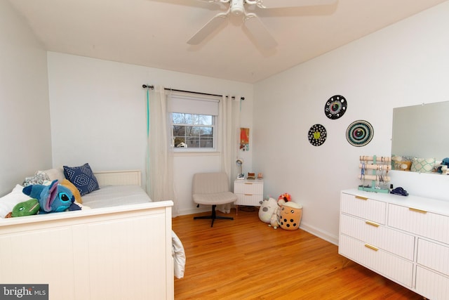 bedroom with ceiling fan, baseboards, and light wood-style floors