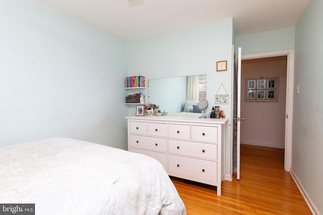 bedroom featuring light wood-style flooring and baseboards