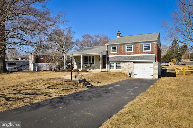 tri-level home featuring driveway, fence, a front yard, a garage, and a chimney