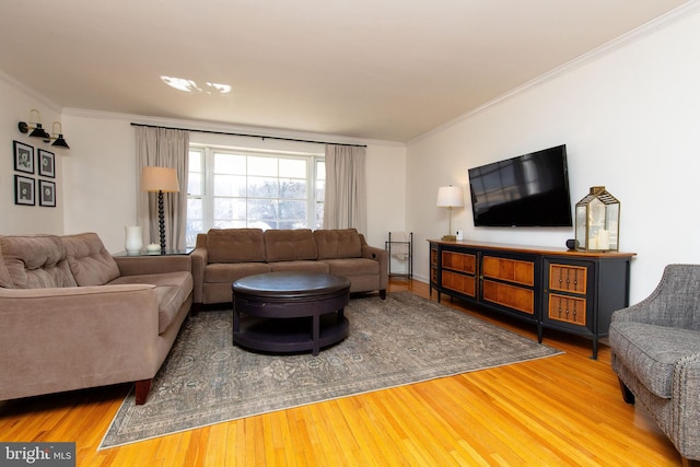 living room with wood finished floors and crown molding