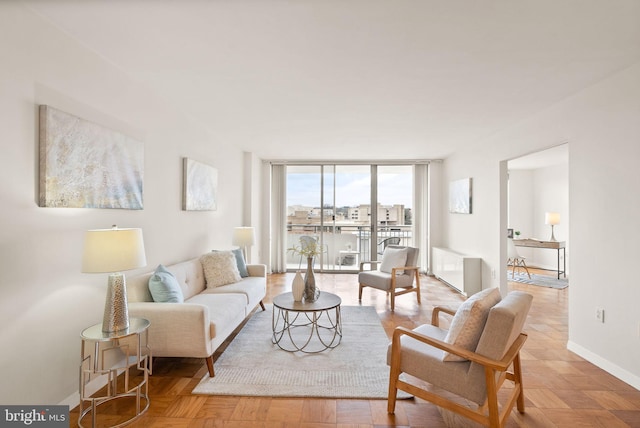 living area featuring expansive windows and baseboards