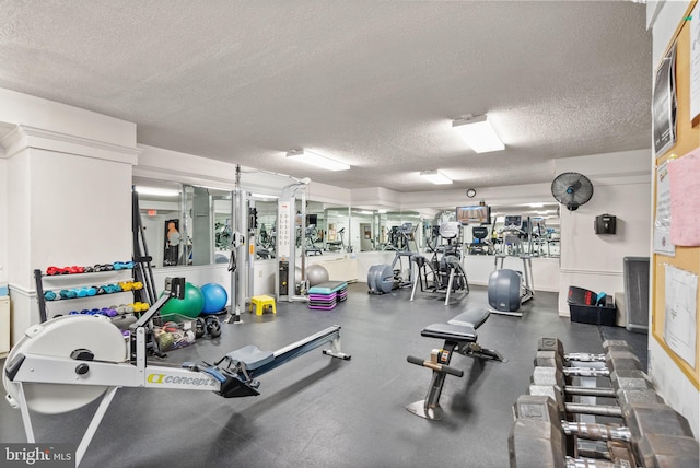 gym featuring a textured ceiling