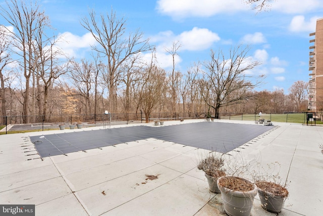 view of swimming pool with fence, a fenced in pool, and a patio