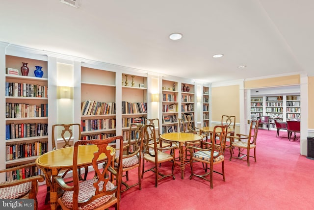 living area featuring recessed lighting, carpet flooring, and wall of books