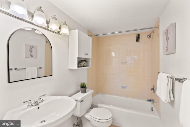 full bath featuring a sink, bathing tub / shower combination, and toilet