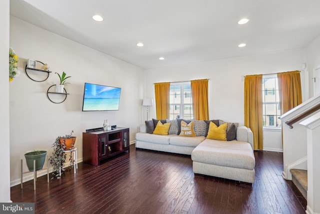 living room with hardwood / wood-style flooring, stairs, baseboards, and recessed lighting