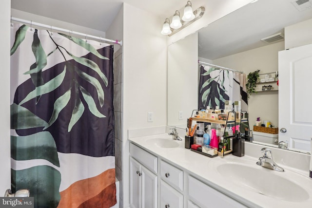 full bathroom featuring visible vents, a sink, and double vanity