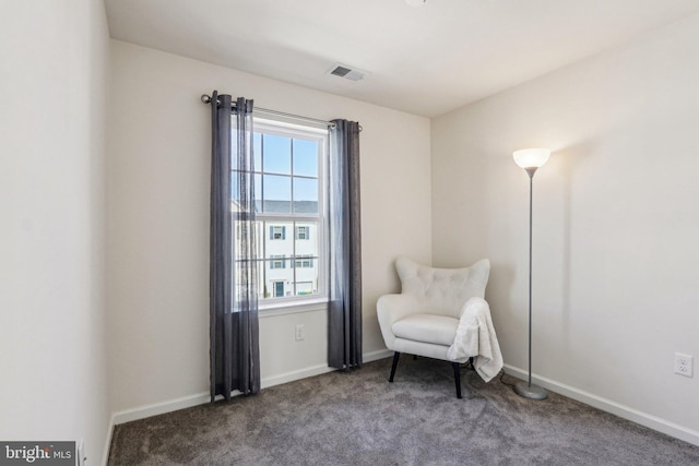 living area with a healthy amount of sunlight, carpet flooring, visible vents, and baseboards