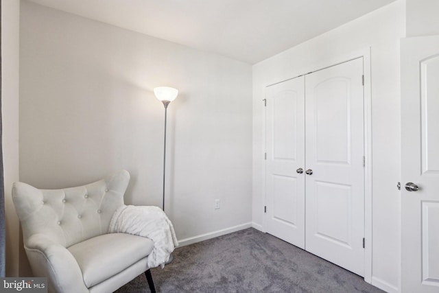 sitting room featuring baseboards and carpet flooring