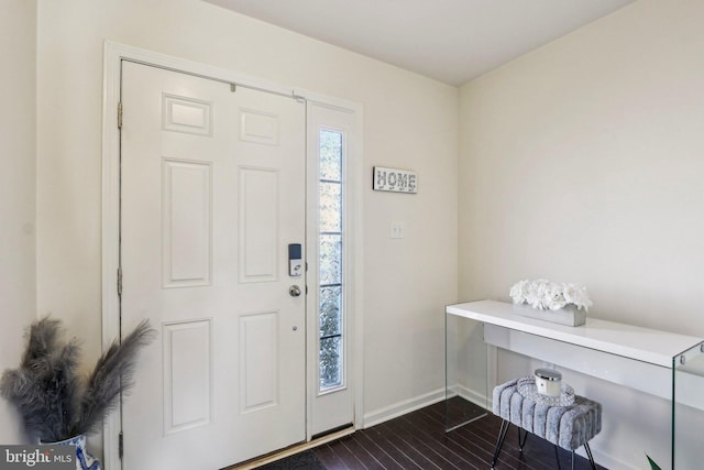 foyer entrance featuring baseboards and dark wood-style flooring