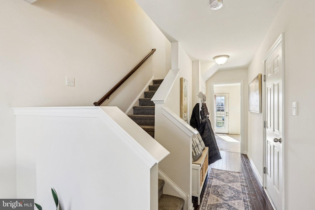 corridor with stairway and wood finished floors