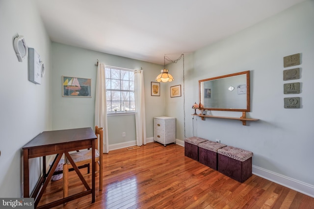 interior space featuring hardwood / wood-style floors, visible vents, and baseboards