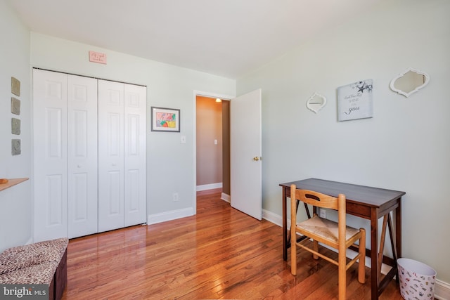 dining area featuring light wood-style flooring and baseboards