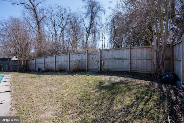 view of yard featuring a gate and a fenced backyard