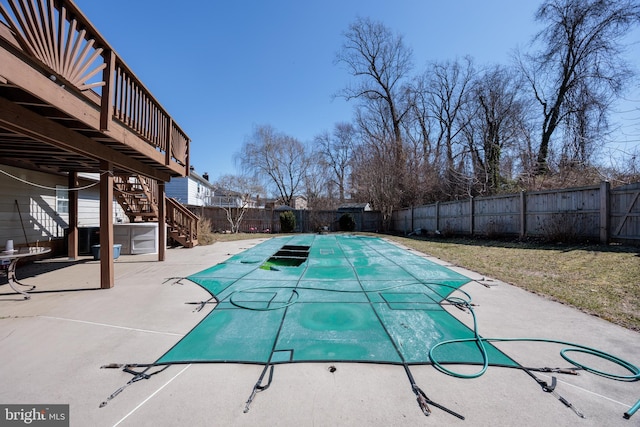 view of swimming pool with a fenced backyard, stairs, a deck, and a patio