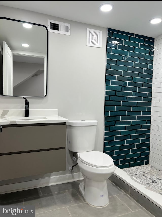 full bathroom with visible vents, toilet, tile patterned flooring, vanity, and a shower stall