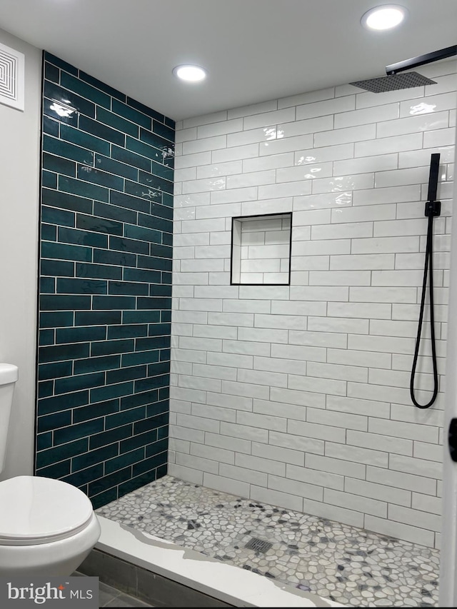 bathroom featuring recessed lighting, a shower stall, and toilet