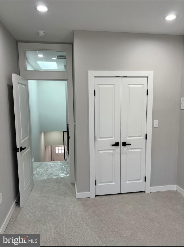 hallway with carpet, visible vents, baseboards, and recessed lighting