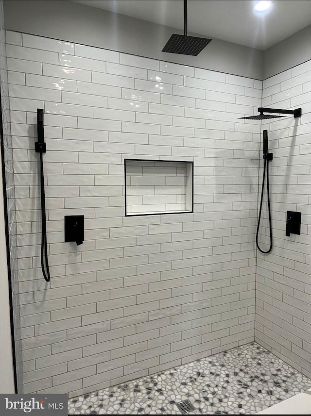 full bath with a tile shower