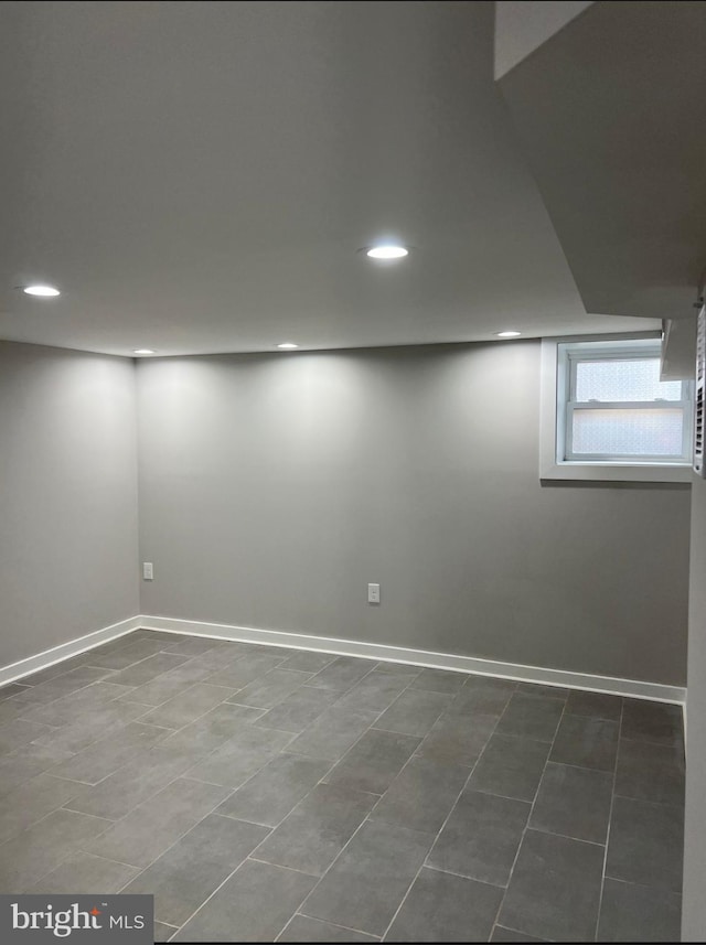 below grade area featuring baseboards and recessed lighting