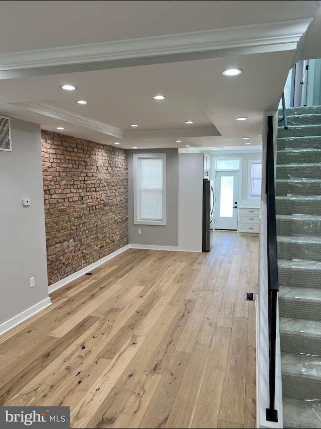 basement with crown molding, recessed lighting, stairway, light wood-style flooring, and freestanding refrigerator