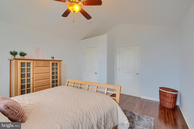 bedroom with ceiling fan, hardwood / wood-style flooring, baseboards, and vaulted ceiling