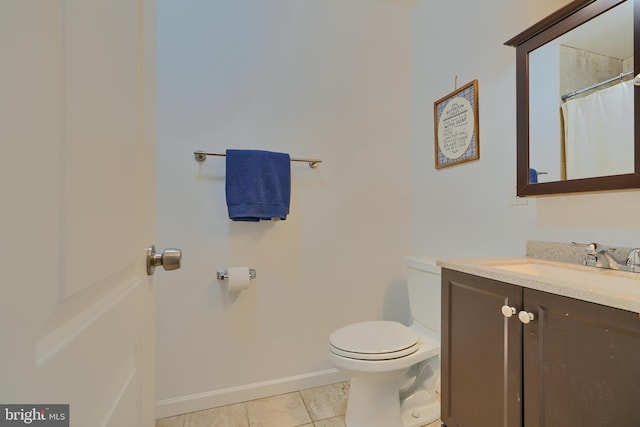 full bath featuring tile patterned flooring, toilet, vanity, and baseboards