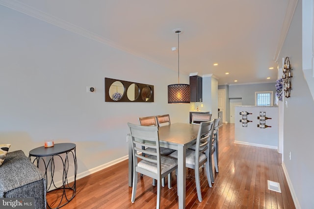 dining space with visible vents, baseboards, recessed lighting, ornamental molding, and wood-type flooring