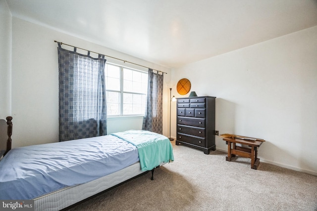 carpeted bedroom featuring baseboards