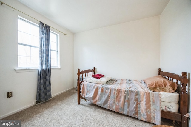 carpeted bedroom featuring baseboards