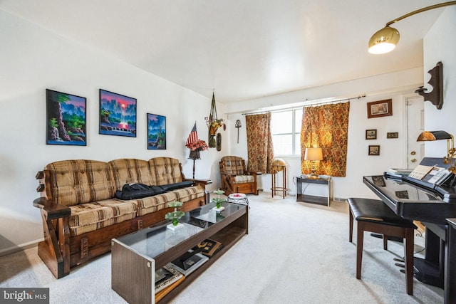 living area with light colored carpet and baseboards