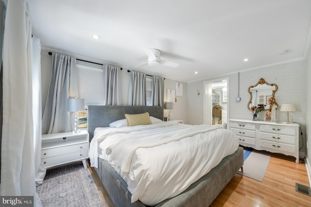 bedroom featuring visible vents, recessed lighting, ceiling fan, ornamental molding, and light wood-style floors