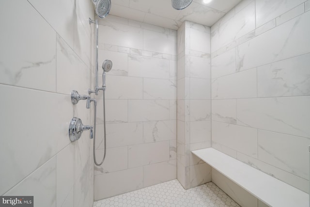 full bath with a tile shower