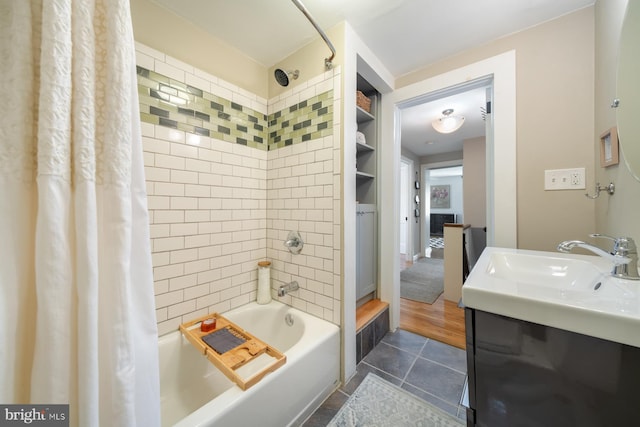 bathroom featuring tile patterned floors, a sink, and shower / bathtub combination with curtain