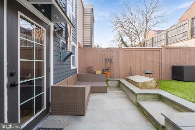 view of patio with an outdoor living space, central air condition unit, and a fenced backyard