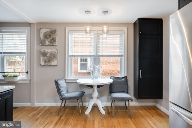 dining room featuring baseboards and light wood-style flooring