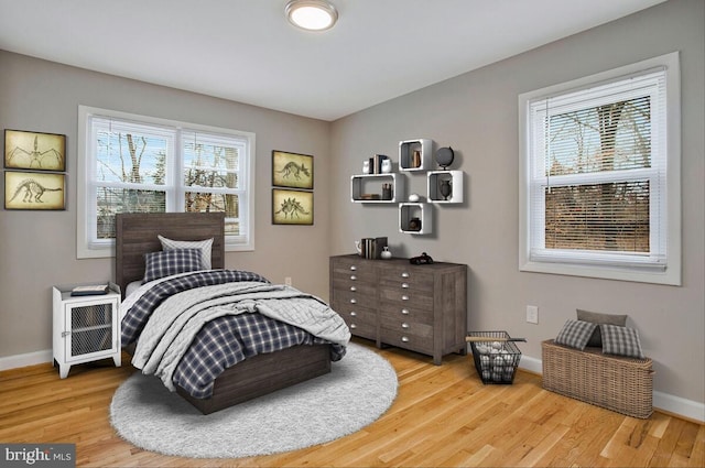 bedroom with baseboards and wood finished floors