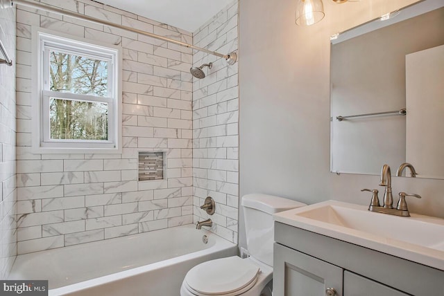 bathroom with shower / bathing tub combination, vanity, and toilet