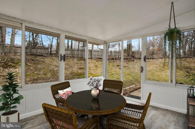 sunroom featuring vaulted ceiling and a wealth of natural light