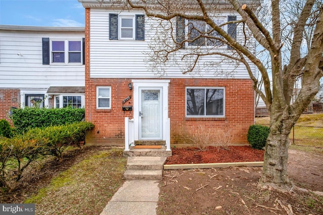 multi unit property with brick siding and fence