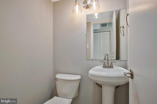 half bath with toilet and visible vents