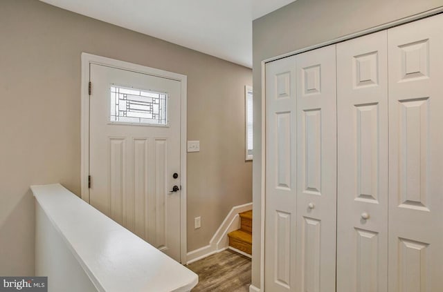 entryway featuring stairway, baseboards, and wood finished floors